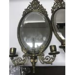 A pair of Victorian oval mirrors with classical de