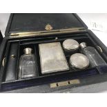 Two Edwardian leather vanity cases with fitted int