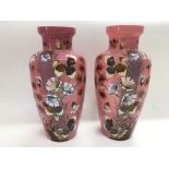 A pair of Victorian pink glass vases with hand pai