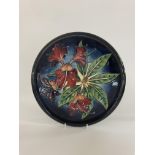 A Moorcroft pottery charger with Simeon pattern by