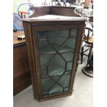 A small Edwardian inlaid corner cabinet with a sin