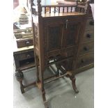 An oak bureau with heavily carved floral panels, g