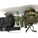A collection of various Airsoft webbing and accessories including holsters and pellets.