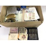 A box of various ephemera including stamps, milita