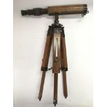 A small brass and leather cased telescope on a woo