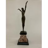 A bronze figure of an Egyptian dancer mounted on a