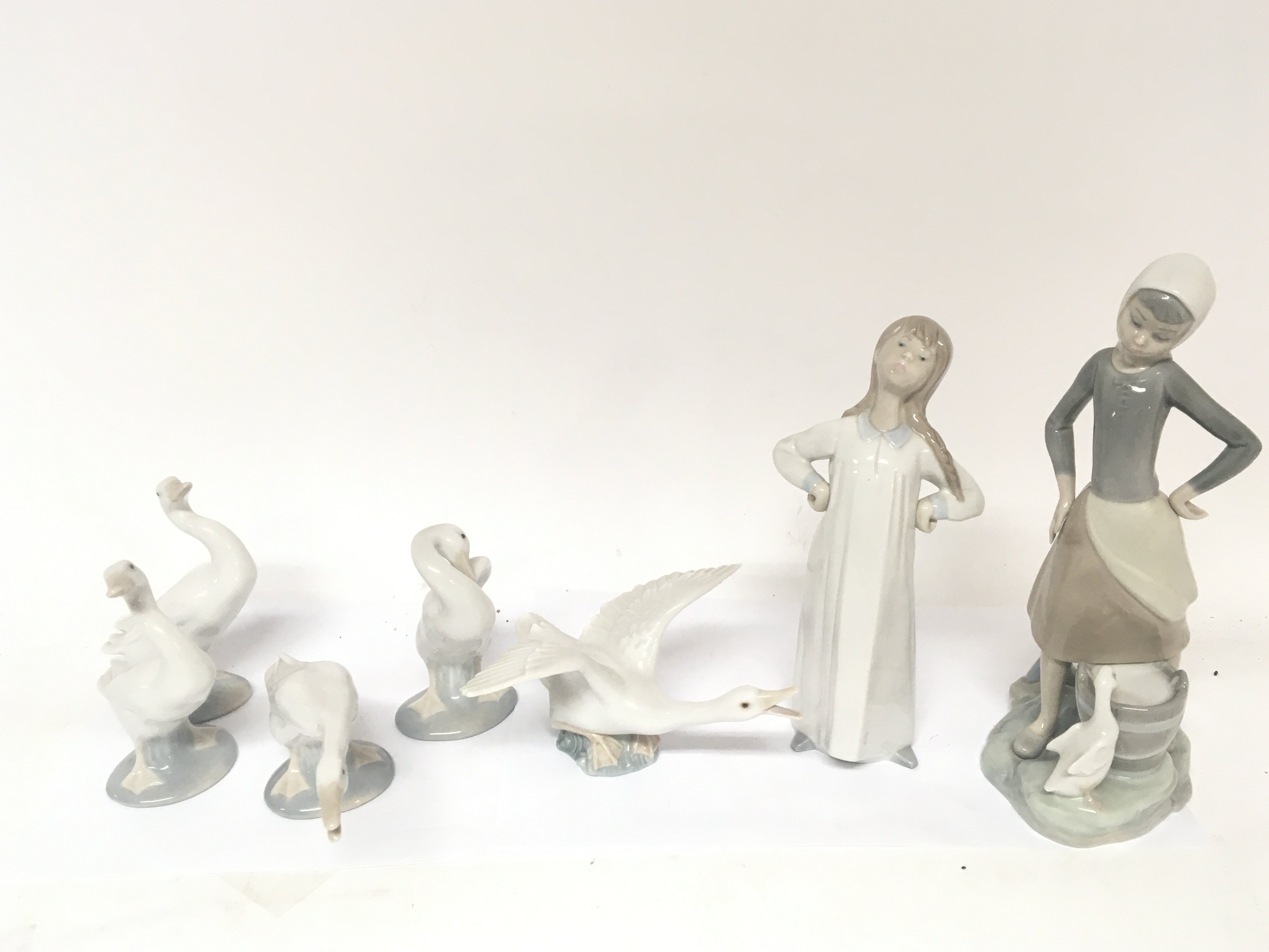 A collection of Lladro Geese a Lladro figure of a