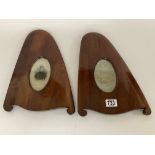 A pair of propeller tip photo frames.