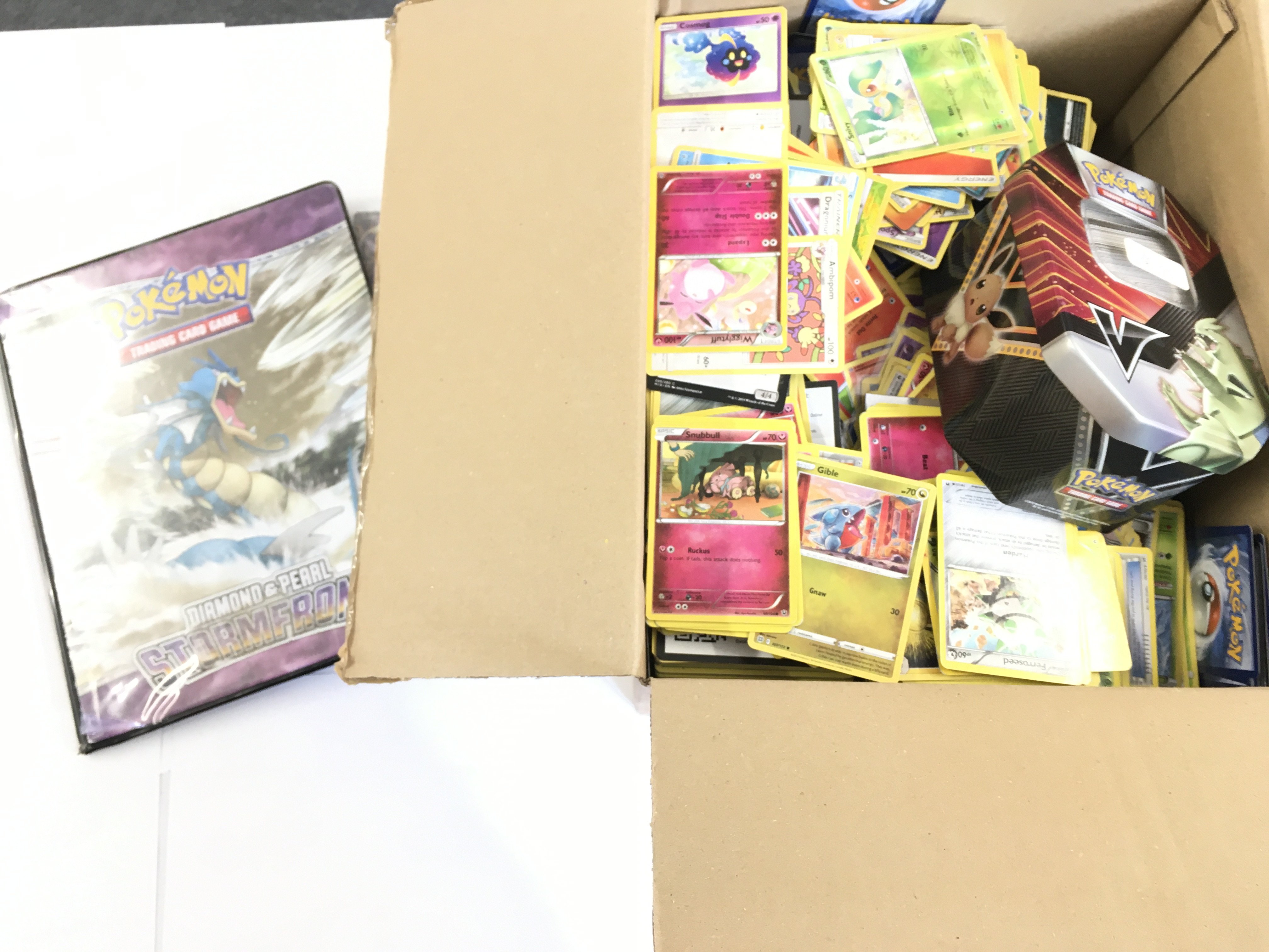 A Box Containing a Collection of modern Pokemon Ca