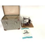 An Essex miniature sewing machine with carry case