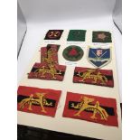 An album containing cloth embroidered Military Div