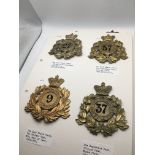 A collection of military Shako plates on four card