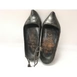 Pair of Dutch clogs that have been crudely engrave