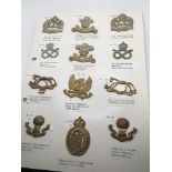 A collection of Military hat badges some pre I wor