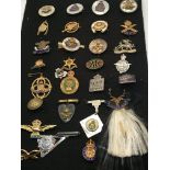 A collection of military regimental badges some mo