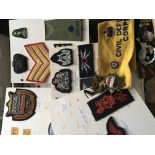 A box containing RAF cloth badges and other milita