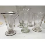 A collection of six medical glass measuring jugs .