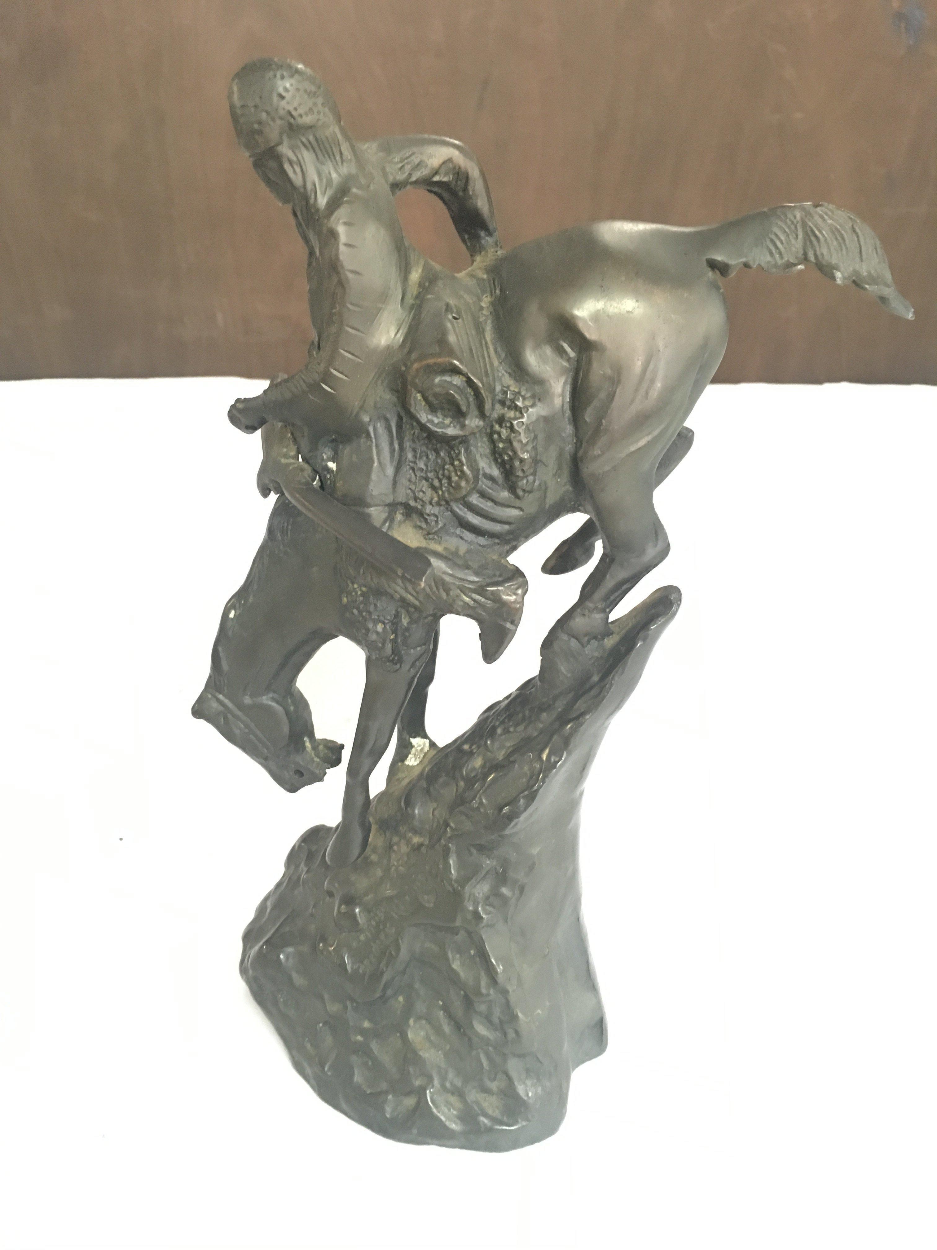 A Cast Bronze Indian on a Horse Inspired by Frederic Remington. Approximate height 24CM.