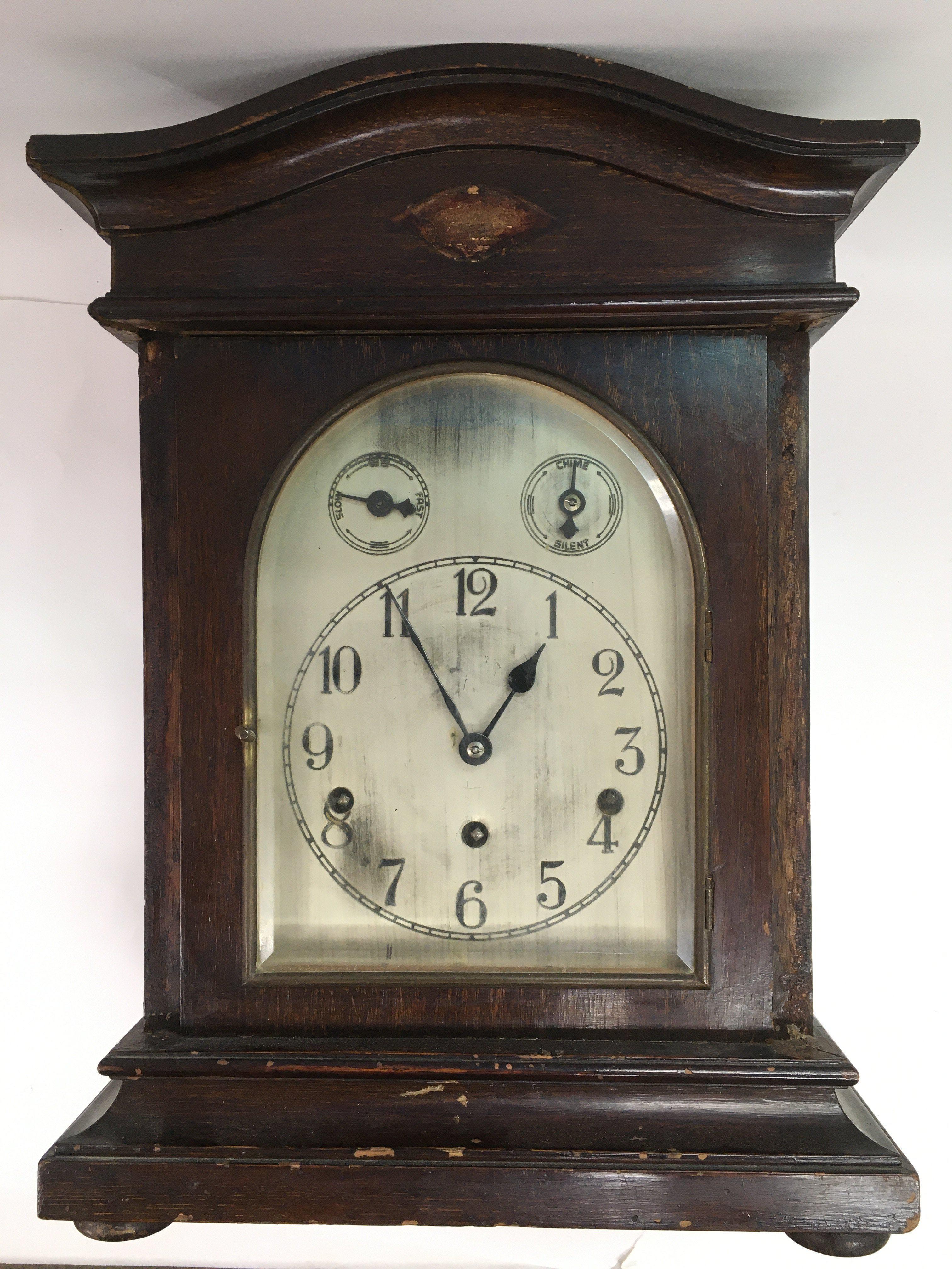 A mahogany cased mantle clock with silvered dial,