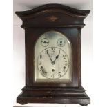 A mahogany cased mantle clock with silvered dial,