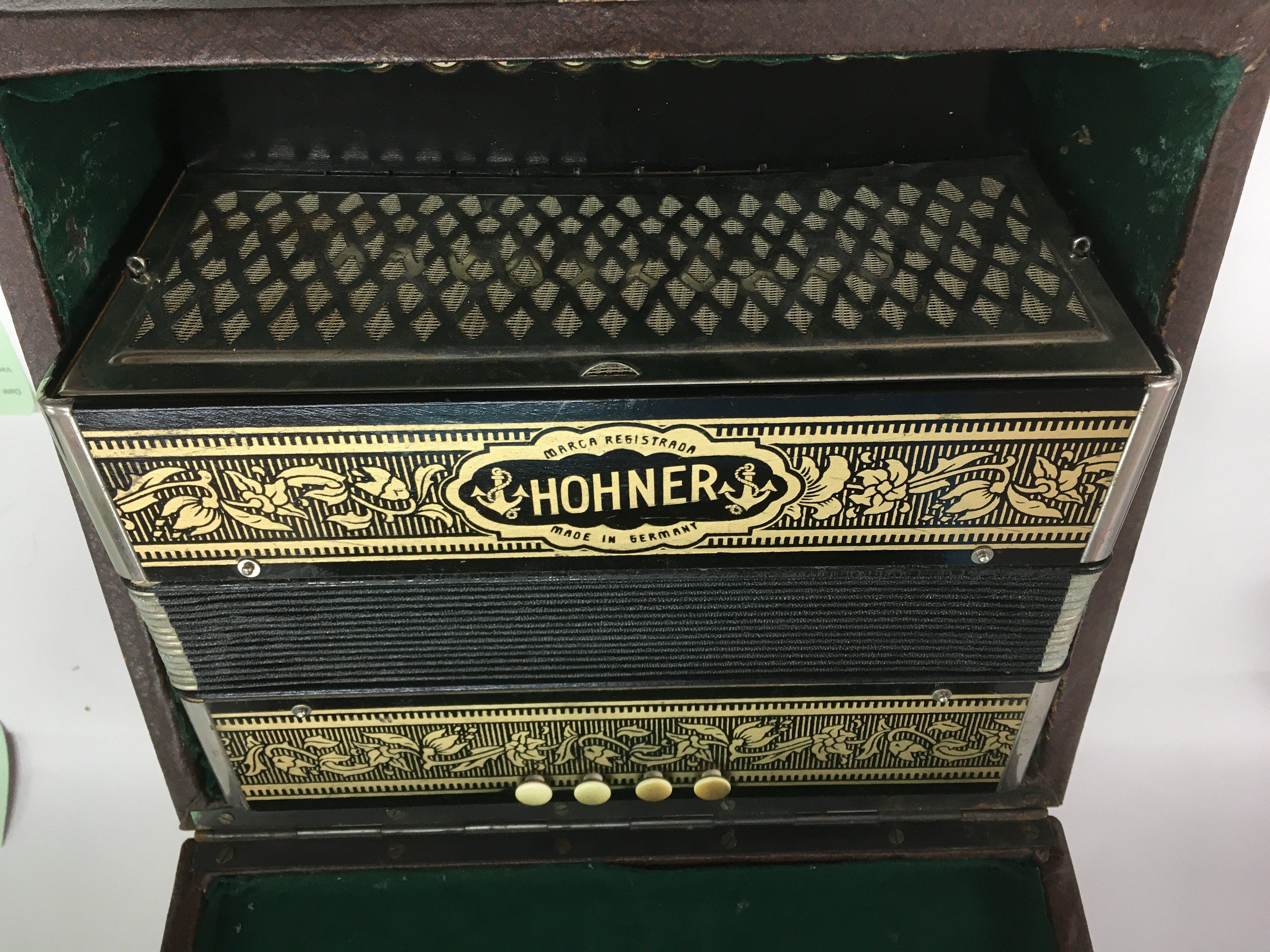 A cased Hohner accordion.