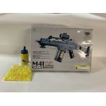 A complete in box M41 series air soft gun with â€œDouble Eagleâ€ gunsight. Can be assembled in