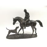 A contemporary sculpture of a huntsman on horsebac