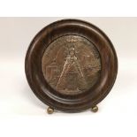 A circular religious plaque in a rosewood frame, s