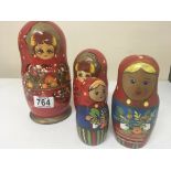 Two Russian painted wood graduating doll sets