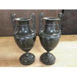 A pair of Victorian urn shaped vases embossed