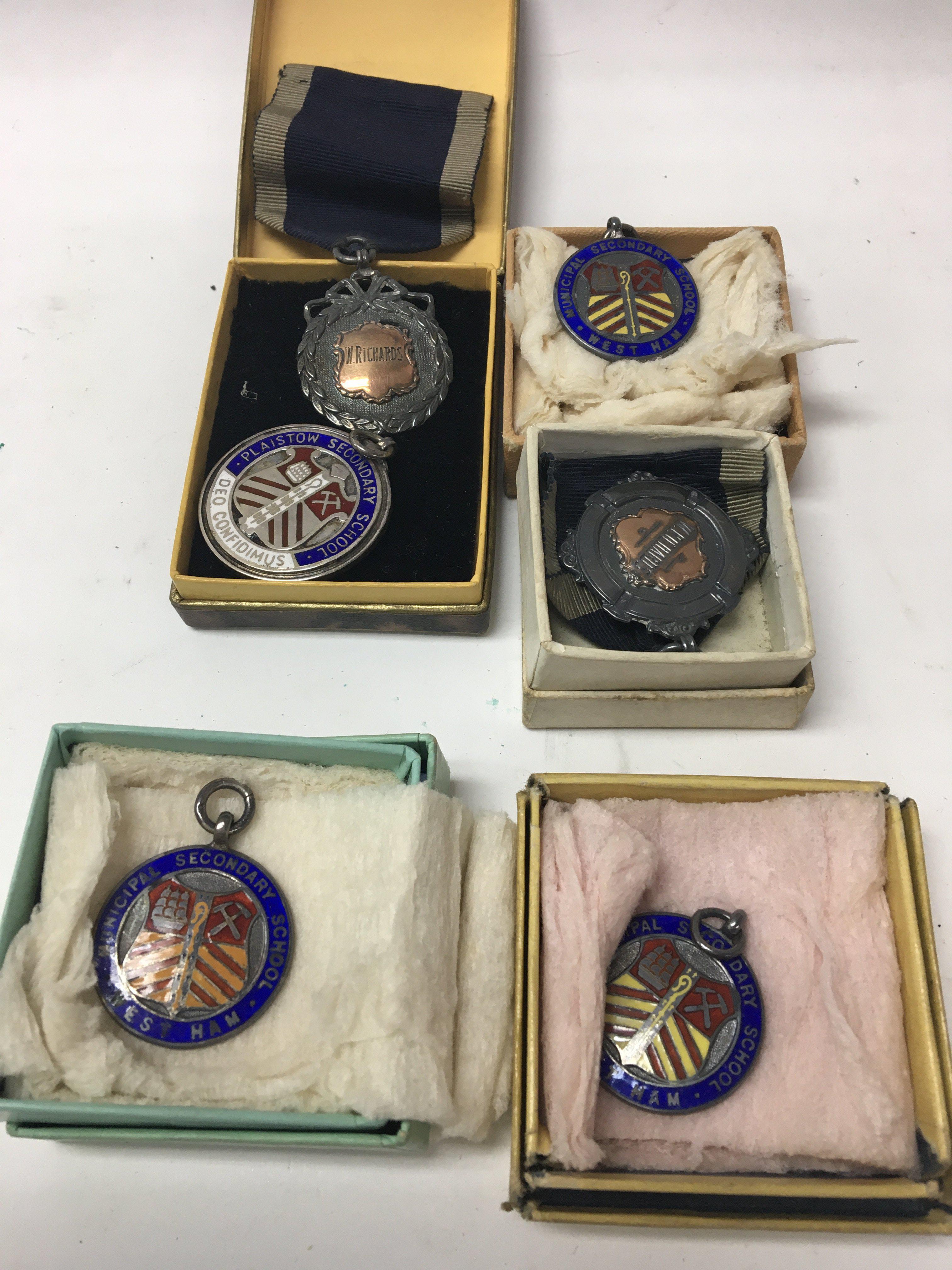 A collection of sporting medallions including silv