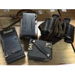 Three cased cameras including Kodak Brownie and a