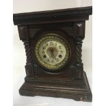 A Continental walnut mantel clock with spiral pila