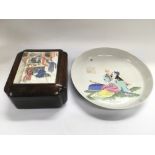 An Oriental dish with a reclining figure to the ce