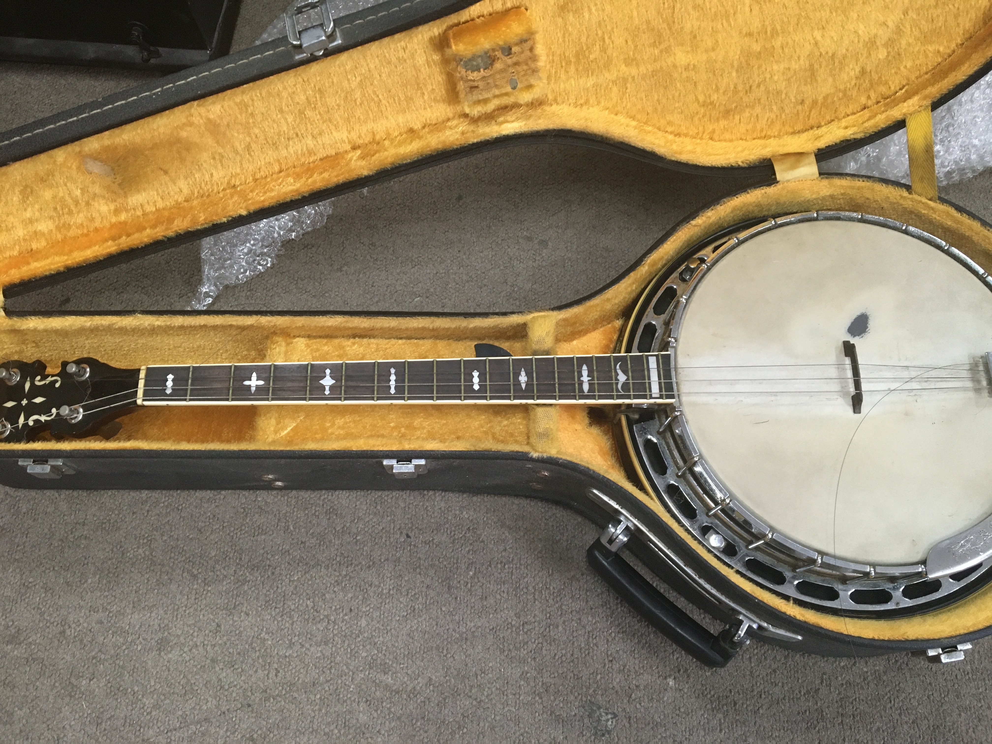 A cased four string banjo