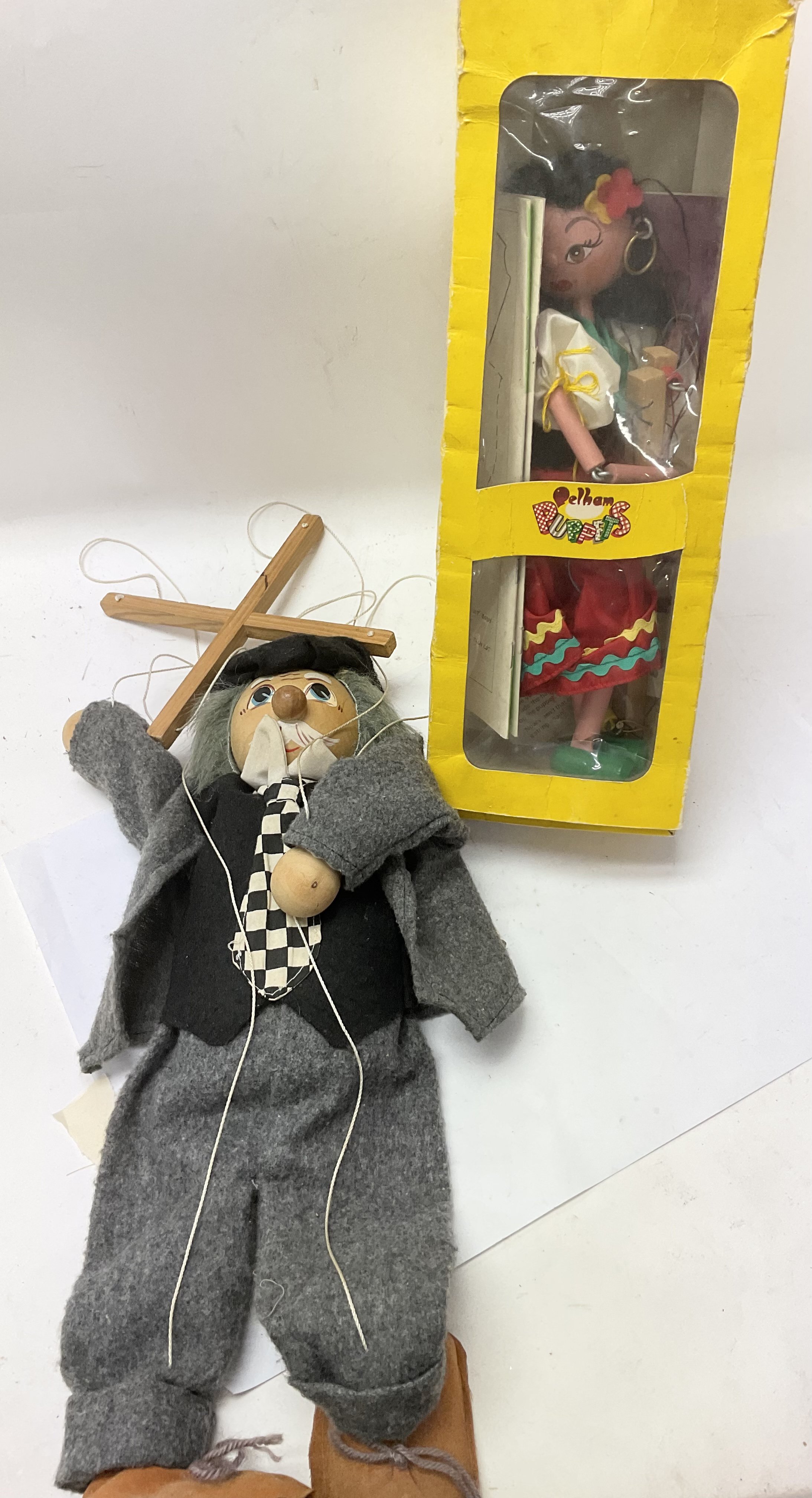 A boxed vintage Pelham puppet and another puppet.