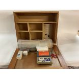 A vintage first aid cabinet, wooden, with a selection of vintage first aid items, including splint