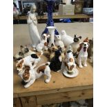 A collection of Royal Doulton dogs and Beswick cat