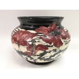 A limited edition Moorcroft vase by Paul Hilditch of squat form in Triumph Of Nature pattern, number