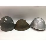 Three military helmets.