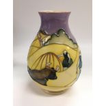 A Moorcroft trial vase depicting workers in a wheat field, approx height 18.5cm.