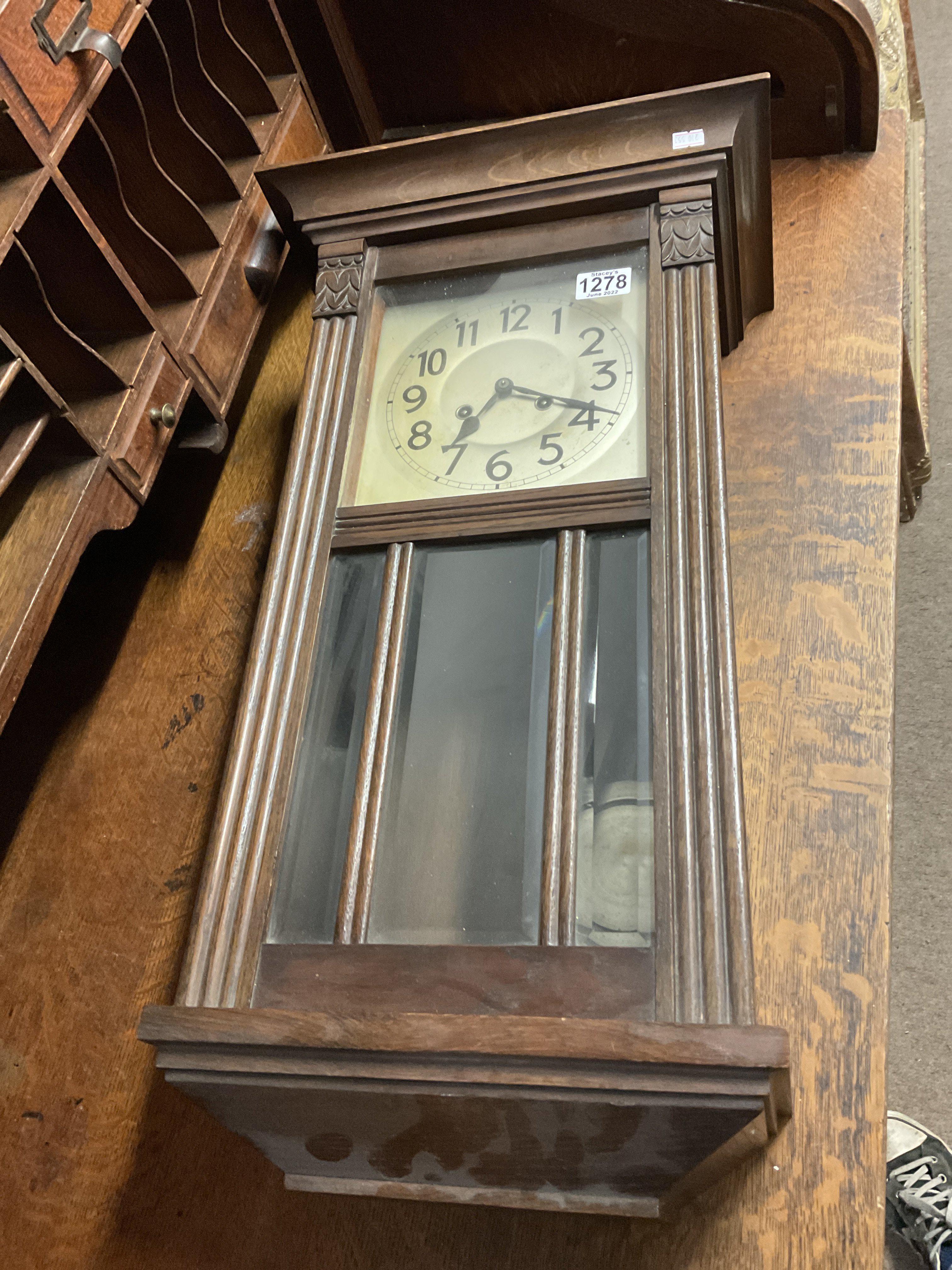 A 1930s oak wall clock