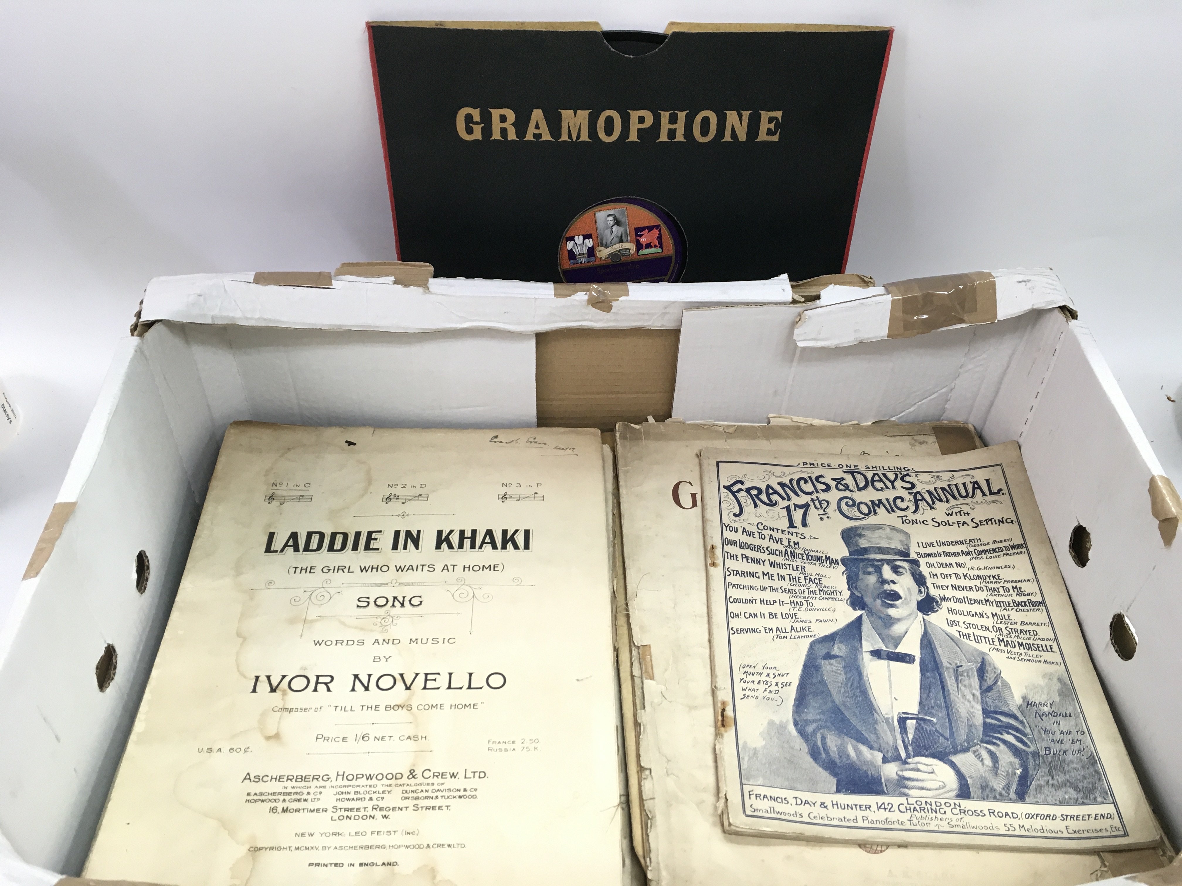 A box of antique sheet music and a scarce gramopho