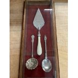 Good display case containing a white metal trowel