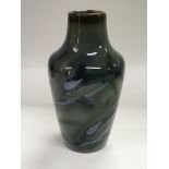 A Cobridge stoneware vase decorated with dolphins,