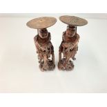 A pair of antique oriental carved figures, approximately 33cm tall.