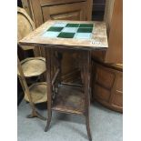 An Arts and Crafts style occasional table with a t