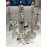 A three branch glass table lamp and four glass candlesticks (5).