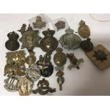 A collection of British military cap badges and he