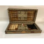 A Inlaid backgammon board, complete with set of 15 black and 15 white pieces. Outside of board has a